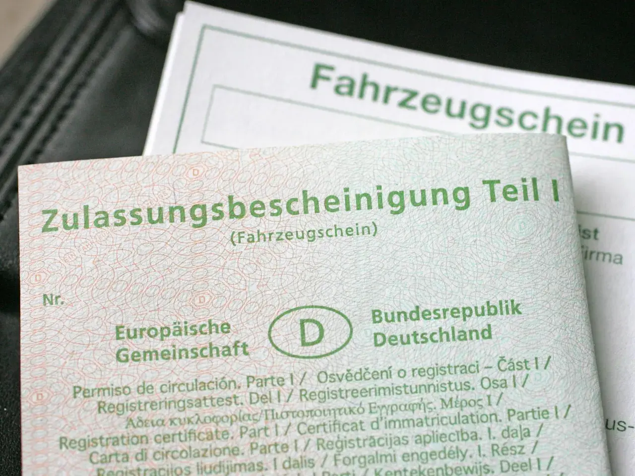 Zulassungsbescheinigung Teil I und Fahrzeugschein mit dem D-Symbol.
