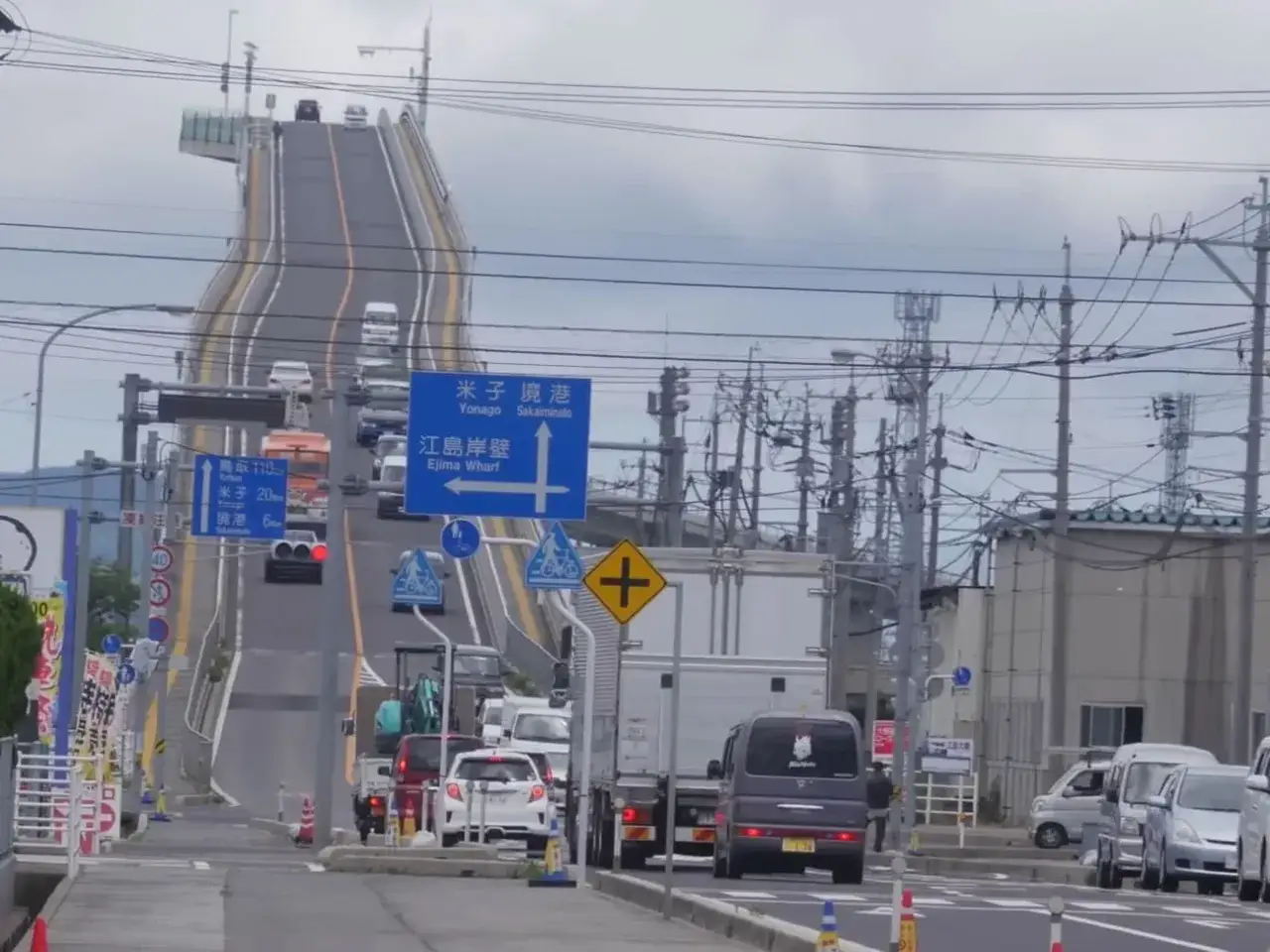 Die Ejima Ohashi Br&uuml;cke ragt steil in den Himmel. Autos fahren auf der ungew&ouml;hnlich steilen Br&uuml;cke.