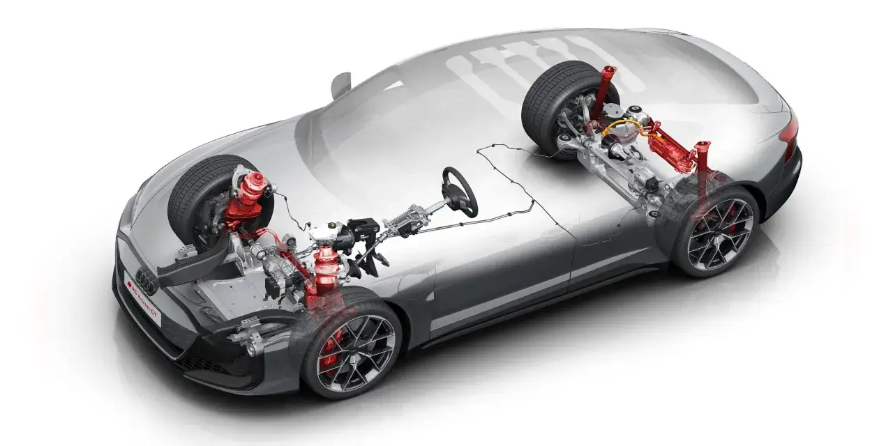 Detailansicht des Fahrwerks eines Elektroautos mit sichtbarer Niveau Regulierung und roten Stoßdämpfern.