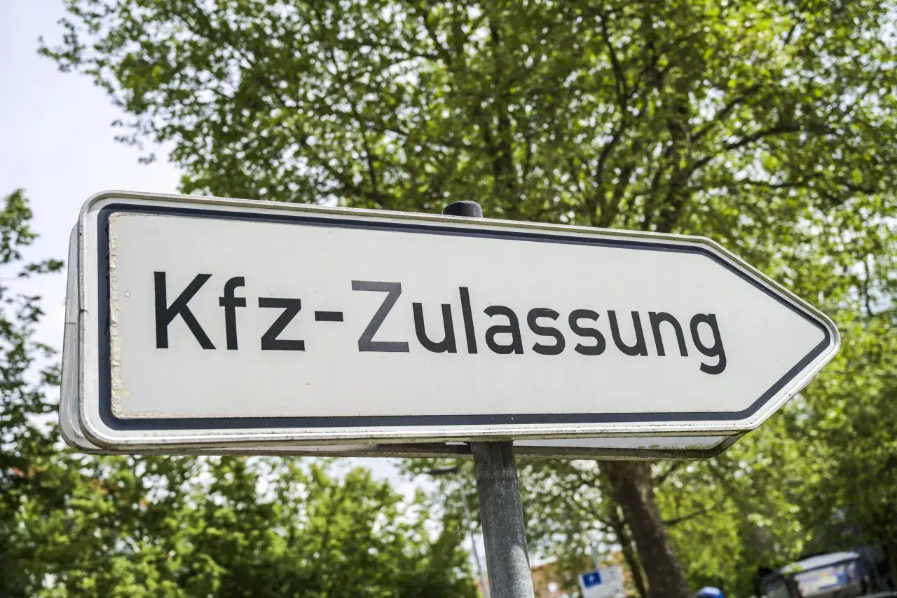 Wegweiser zur Kfz-Zulassungsstelle, wo man neue Kennzeichen bekommt.