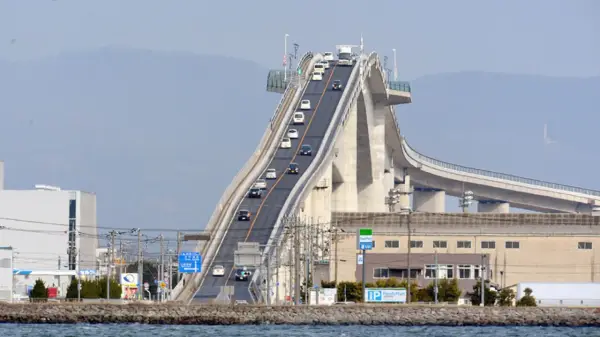 Die Eshima Ohashi Brücke mit Autos, die steil bergauf fahren.
